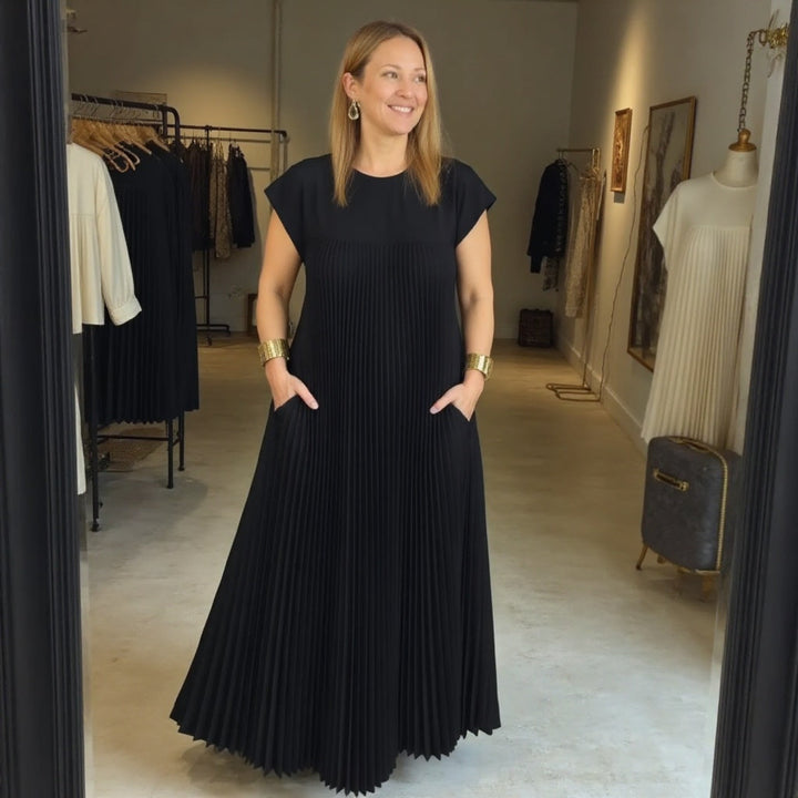 Women's occasion wear: an elegant pleated maxi dress with a comfortable flowing summer style.