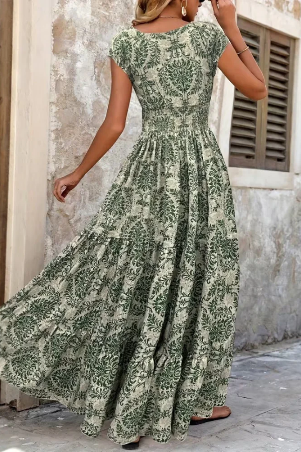 Elegant women's printed V-neck maxi dress, perfect for summer vacations or casual sophisticated day wear. Flowy fabric.