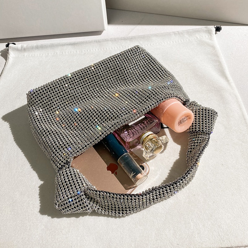 Stylish women's metallic rhinestone evening bag. Adds glam and sparkle to any party outfit.