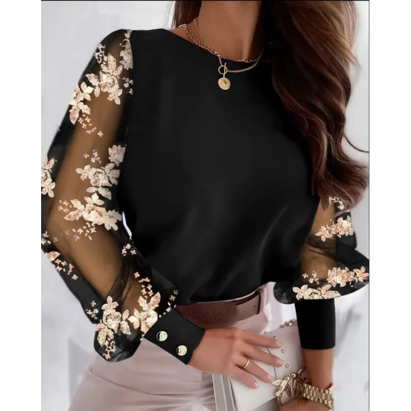 Elegant women's sheer sleeve blouse with delicate appliqué details & round neck. Perfect for fashion-forward looks.