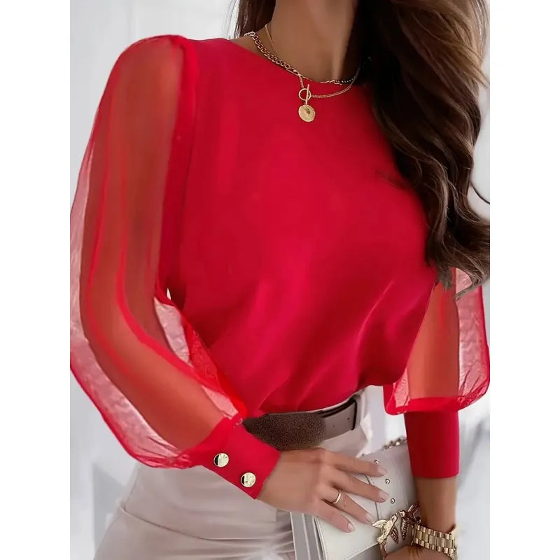 Women's textured blouse featuring elegant sheer appliqué long sleeves & comfortable round neck. Versatile top.