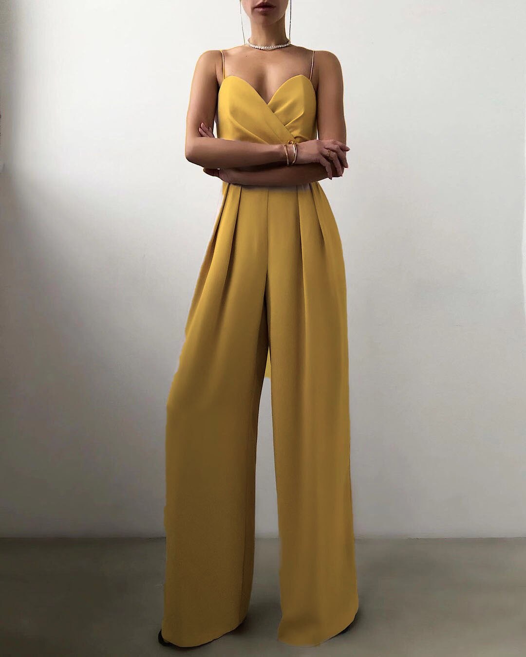 Fashionable women's wide-leg jumpsuit, sleeveless with spaghetti straps, offering a stylish look for special occasions.