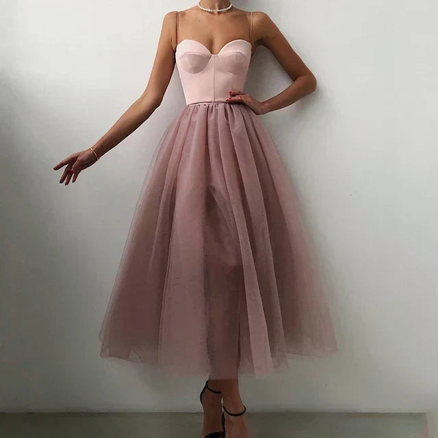 Elegant women's strapless flowing evening gown with pleated skirt for formal events & special occasions.