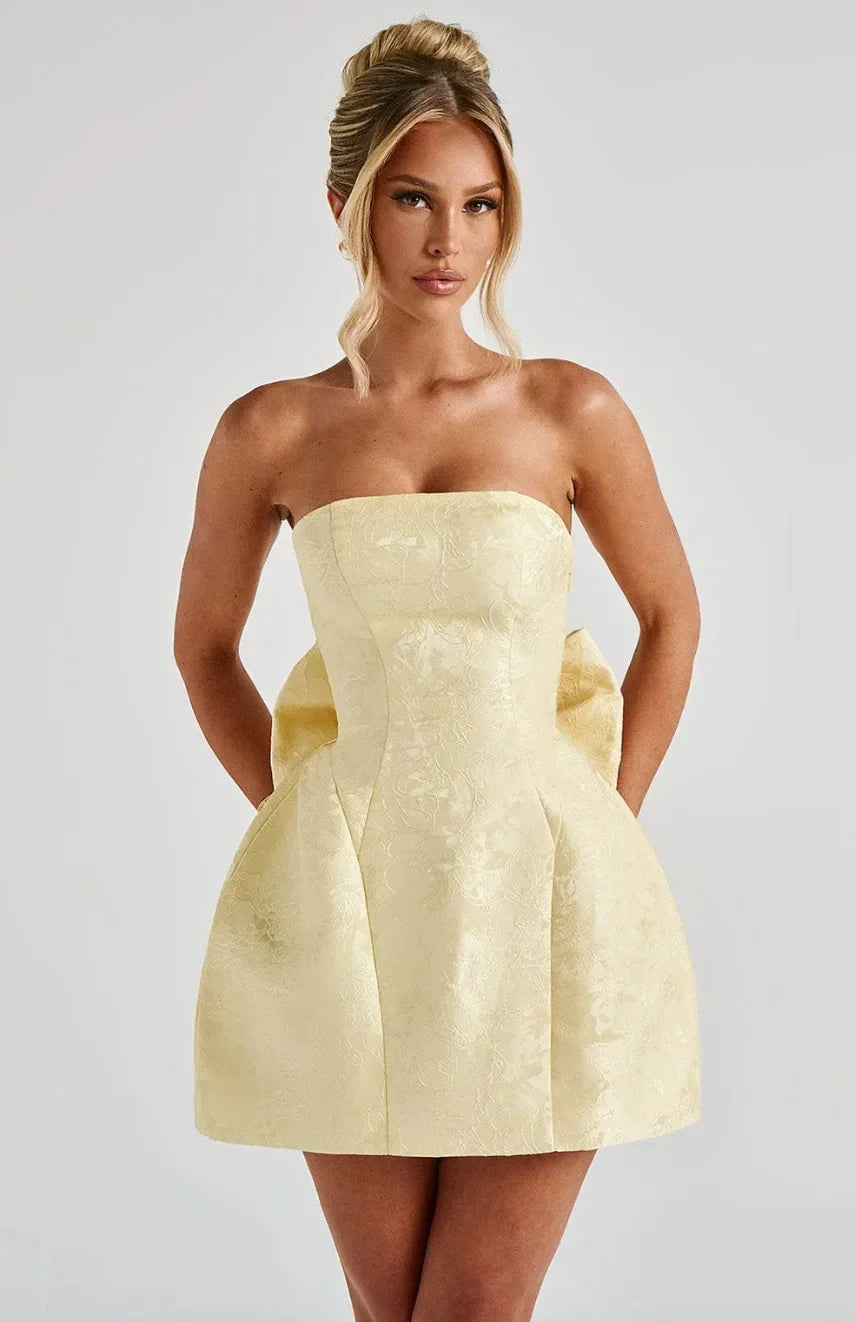Elegant women's strapless mini dress with a charming bow back detail, perfect for special occasions.