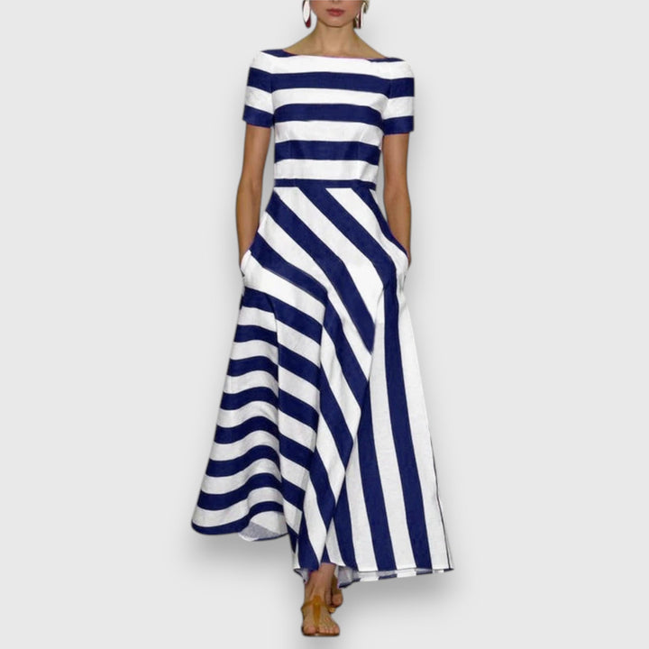 Elegant women's striped maxi dress with bateau neck, short sleeves, and practical pockets. Perfect for summer fashion.