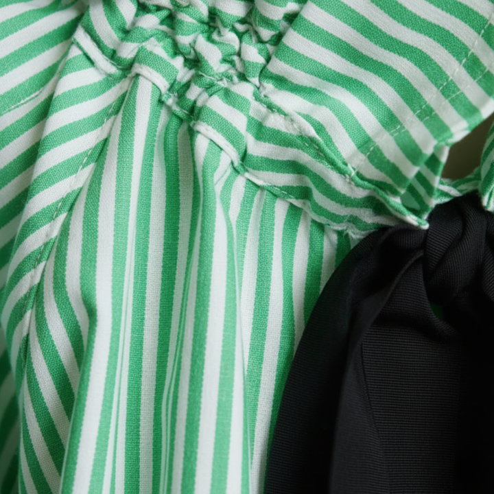 Soft, elegant striped women's blouse featuring a ruffle neck, sophisticated bow tie, and balloon sleeves.