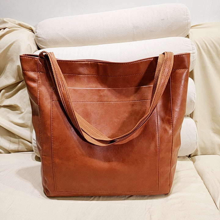 Elegant women's structured tote bag, perfect for work or daily use. Available in classic black, rich brown, & dark brown.