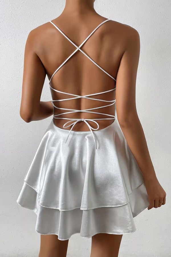 Graceful women's V-neck swing dress featuring an open back detail & flowing pleated skirt. Feminine party wear.