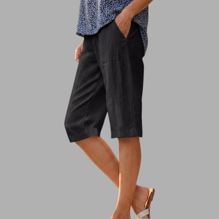 Elegant women's tailored knee-length shorts in classic style, perfect for smart casual summer fashion.