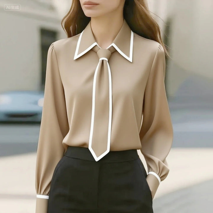 Smart casual women's tie neck blouse. Features elegant contrast trim, long sleeves, and a stylish button-down design.