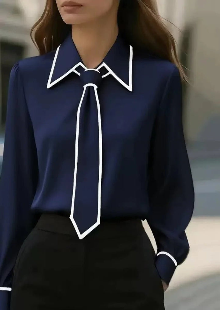 Front view of an elegant women's tie neck blouse, ideal for office or smart casual events. Features contrast trim.
