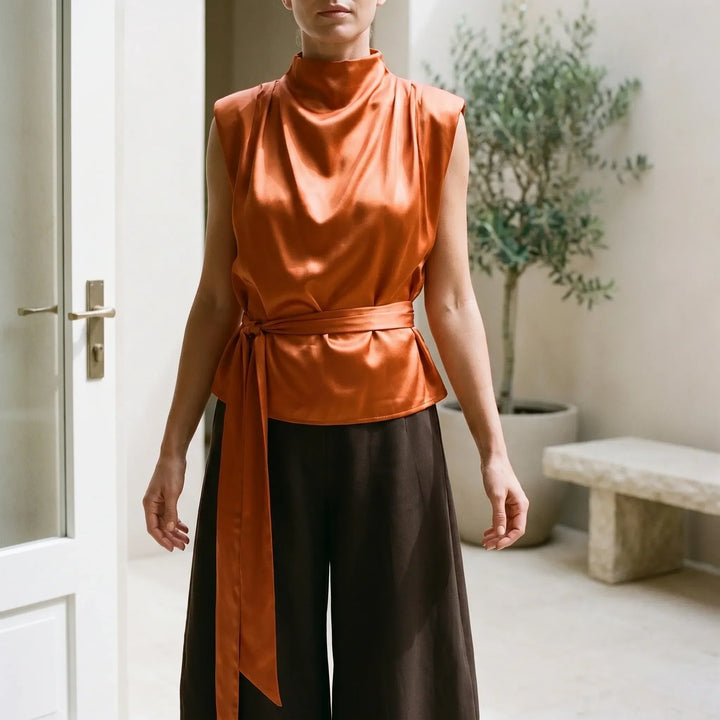 Elegant women's tie-waist cowl neck top for evening wear, sleeveless and textured.