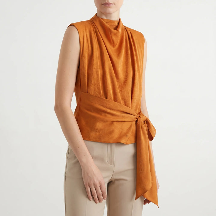 Dressy sleeveless women's blouse with a cowl neck and adjustable tie waist, perfect for evenings.