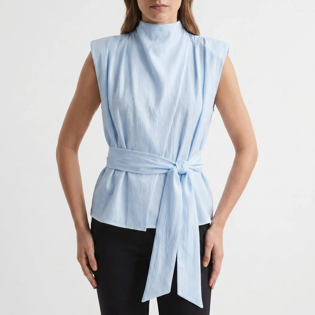 Formal sleeveless women's top with a graceful cowl neck and cinched tie waist for evening events.