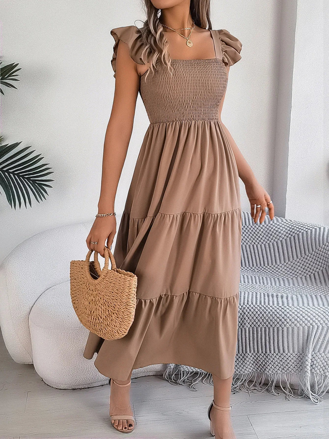 Flowy tiered midi dress for women, featuring a chic design, ideal for summer fashion and elegant wear.