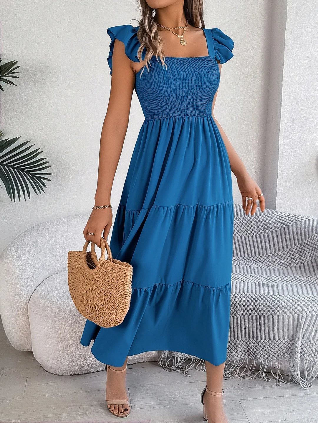 Chic women's elegant midi dress in a tiered, flowy style, perfect for sophisticated summer fashion.