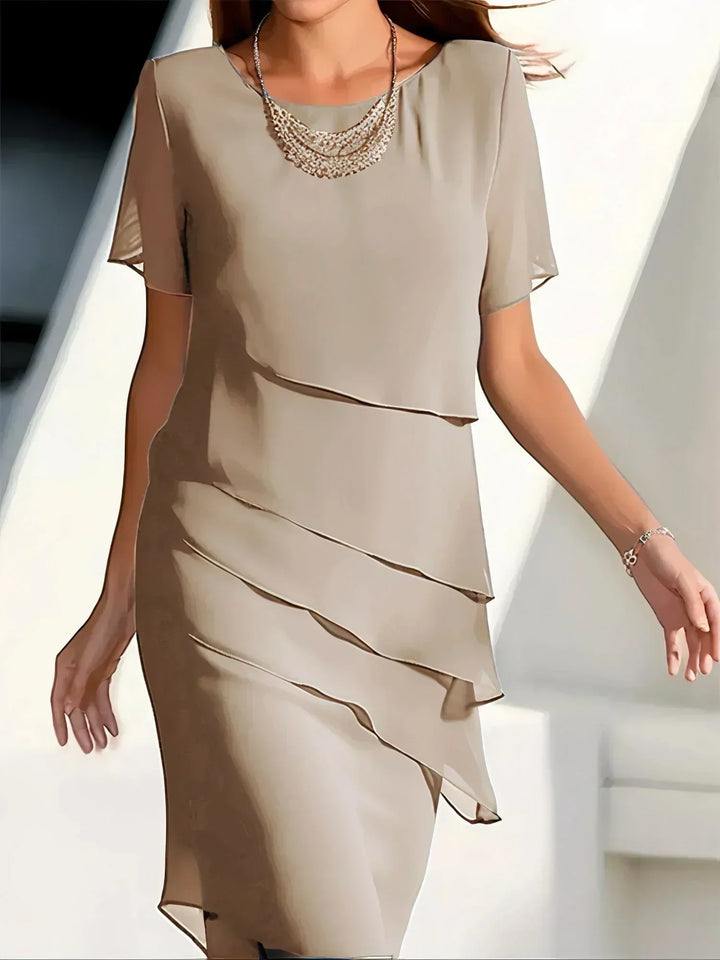 Chic women's tiered midi dress with a round neck, short sleeves, sheer accents & an elegant silhouette.