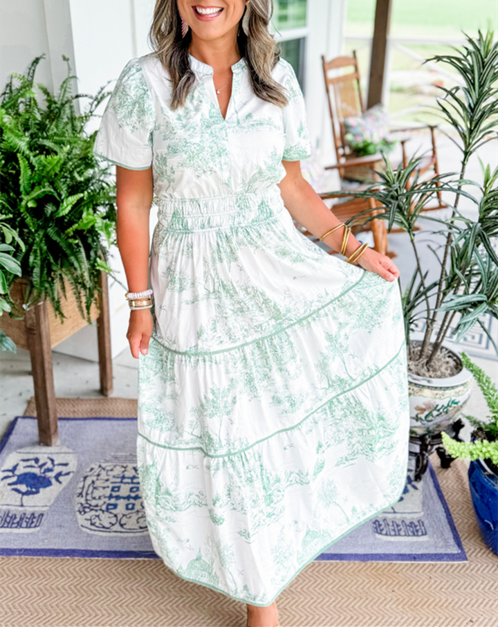 Flowing elegant toile print maxi dress for women, smocked detail, side view.