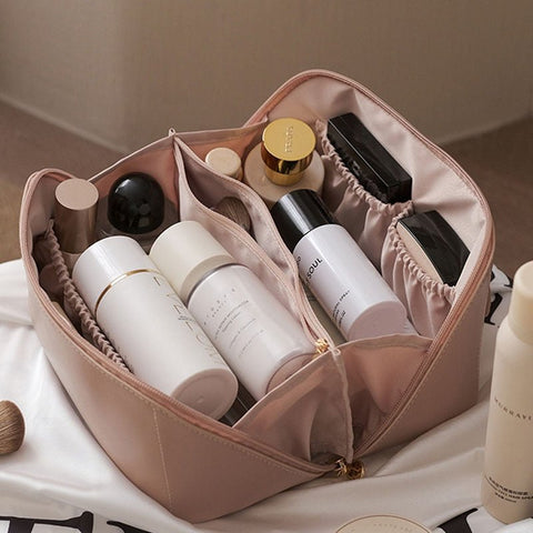 Stylish pink travel makeup bag for women, a compact beauty organizer for toiletries on the go.