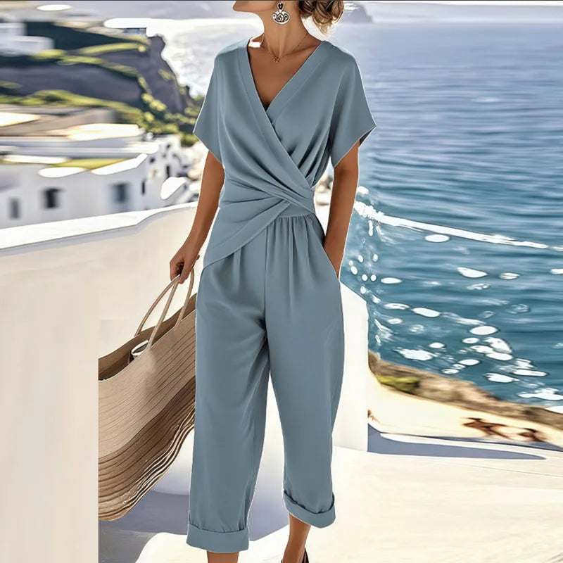 Chic women's two-piece pants set with wrap top & tailored trousers, ideal for vacation, resort wear, or summer elegance.