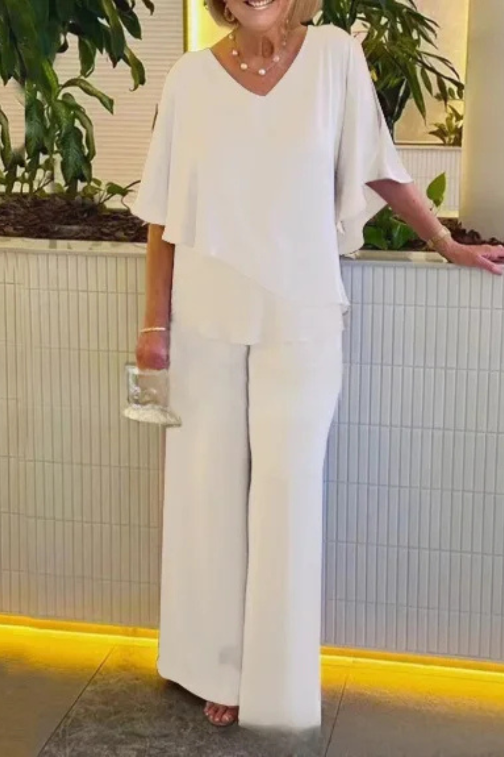 Women's elegant V-neck batwing top & wide-leg trousers set, designed for comfort & sophisticated style.