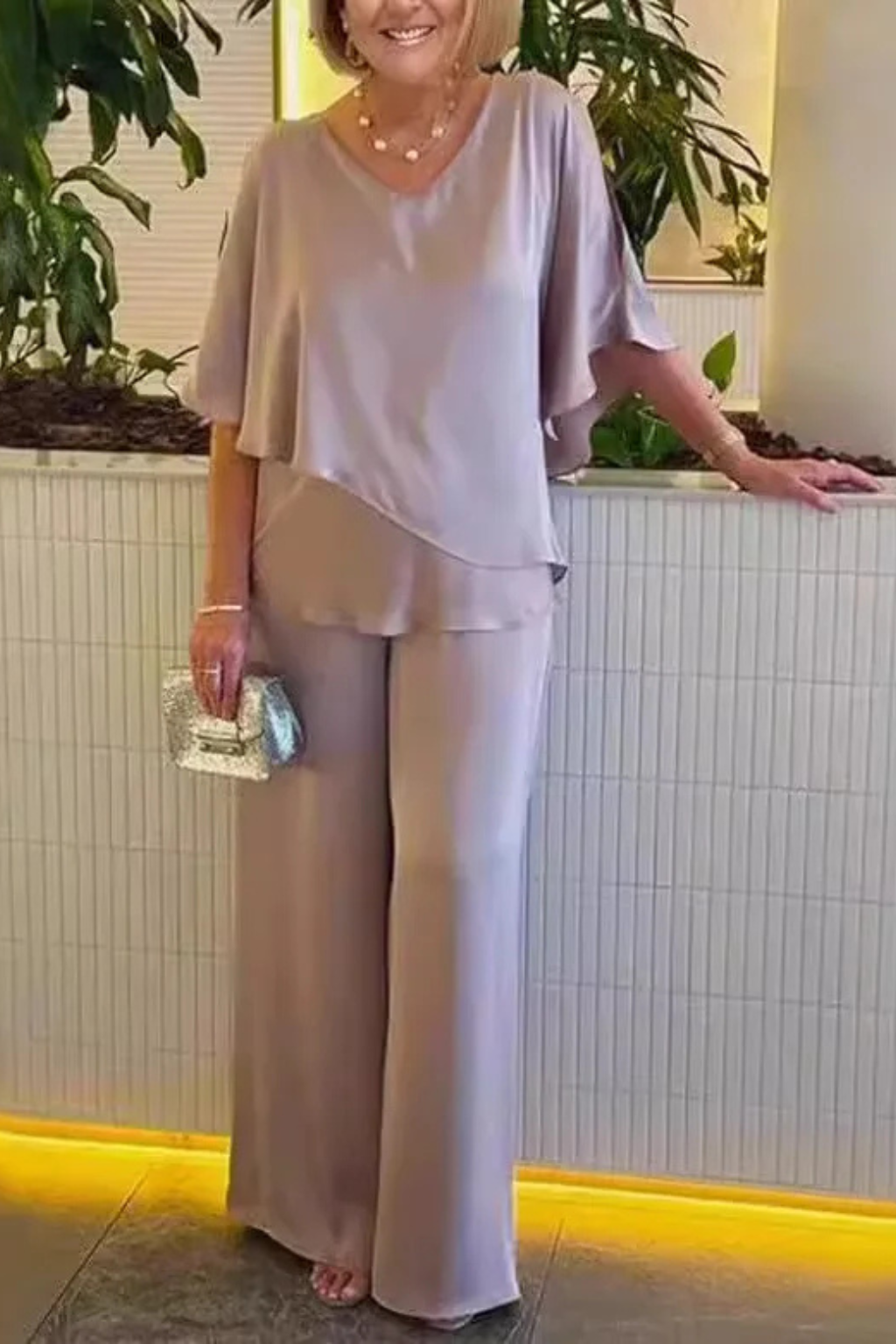 Chic women's coordinated set featuring a V-neck top with batwing sleeves and comfortable wide-leg trousers.