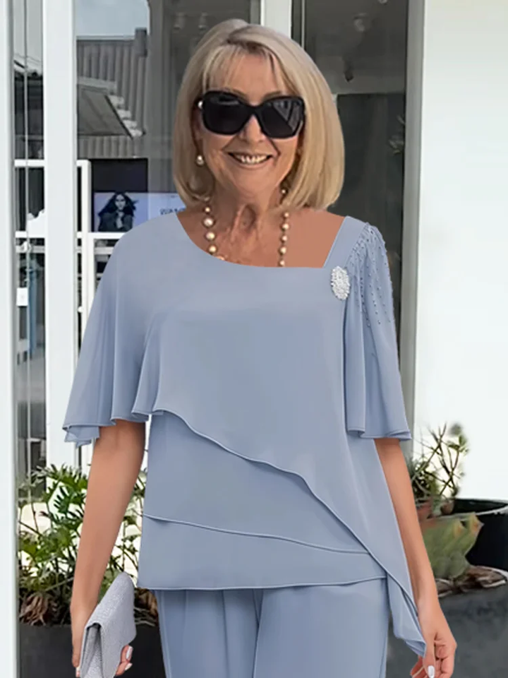 Comfortable straight-leg pants & elegant overlay top matching set for women. Chic two-piece outfit for all-day style.