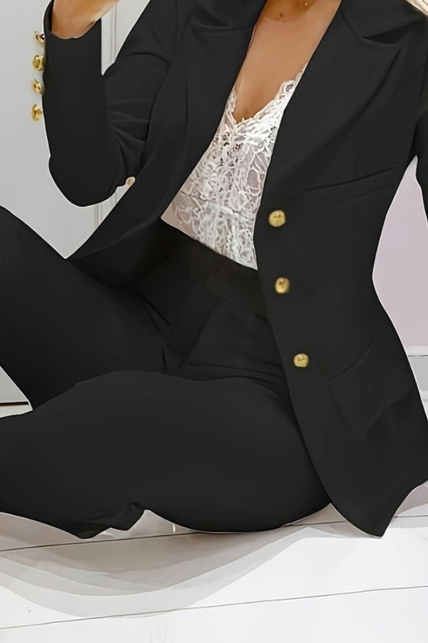 Chic women's two-piece outfit with a trendy blazer and complementing professional trousers.