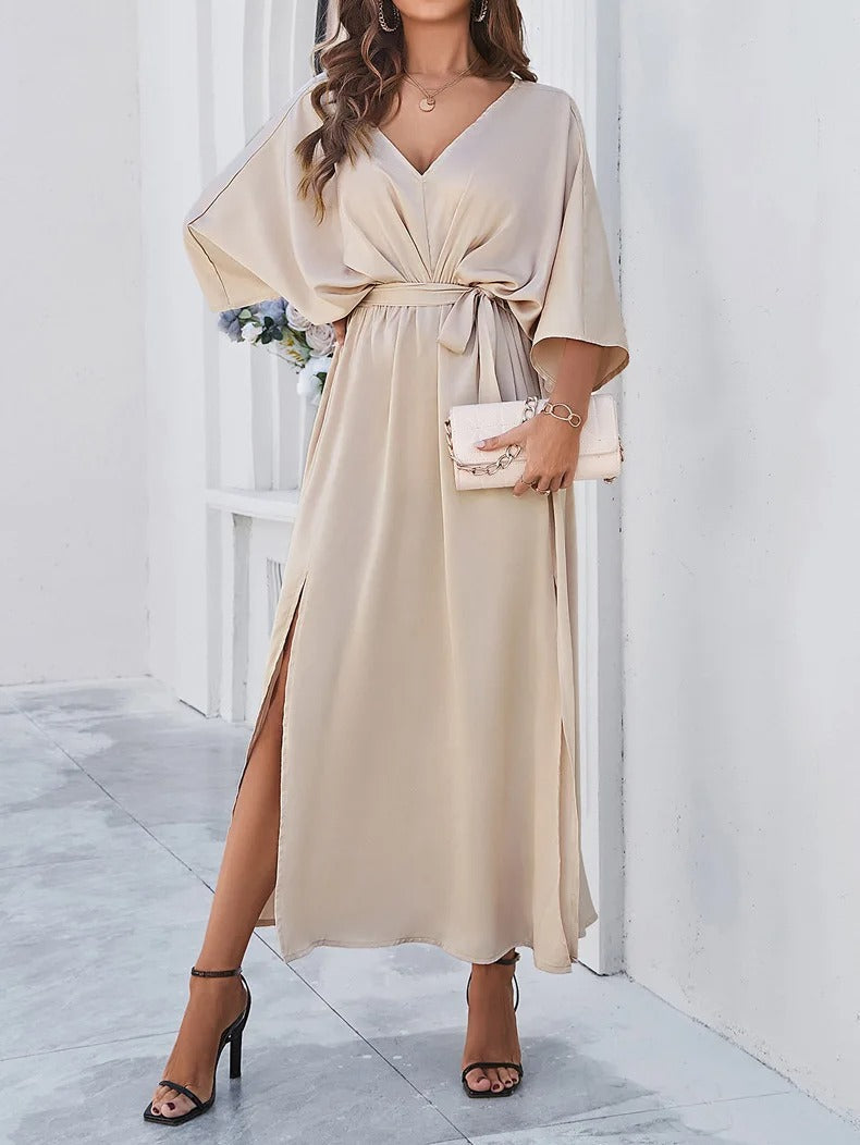 Formal women's V-neck batwing maxi dress with a decorative bow belt & stylish side slit. Elegant evening gown.