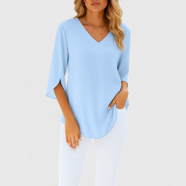 Elegant women's v-neck blouse. Sophisticated summer top with stylish design, perfect for warm weather.
