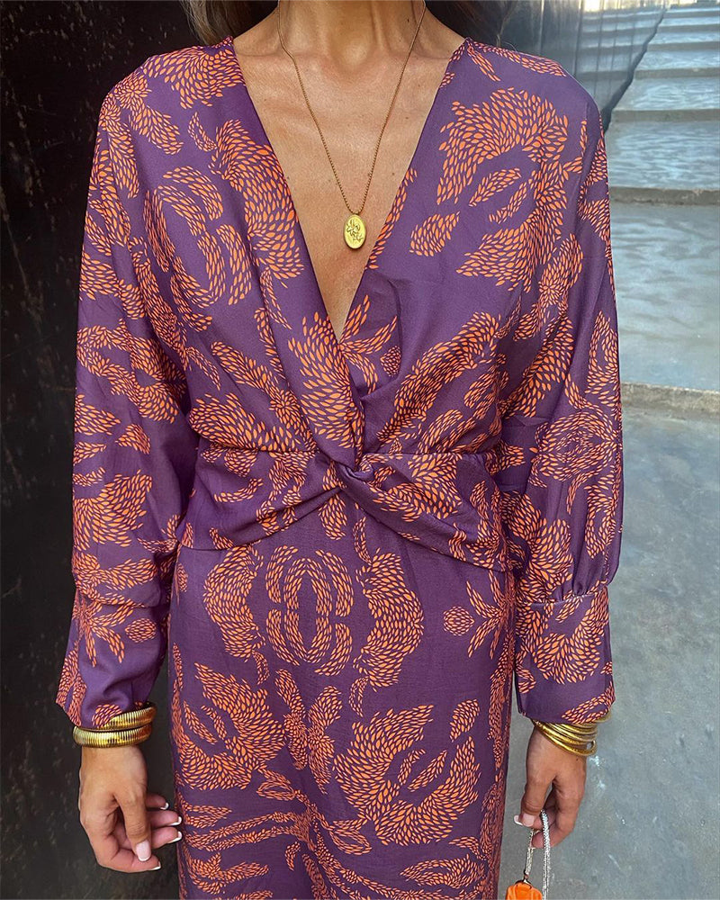 Chic women's elegant midi dress. Features V-neck, knot detail, and long sleeves. Must-have for evening parties.
