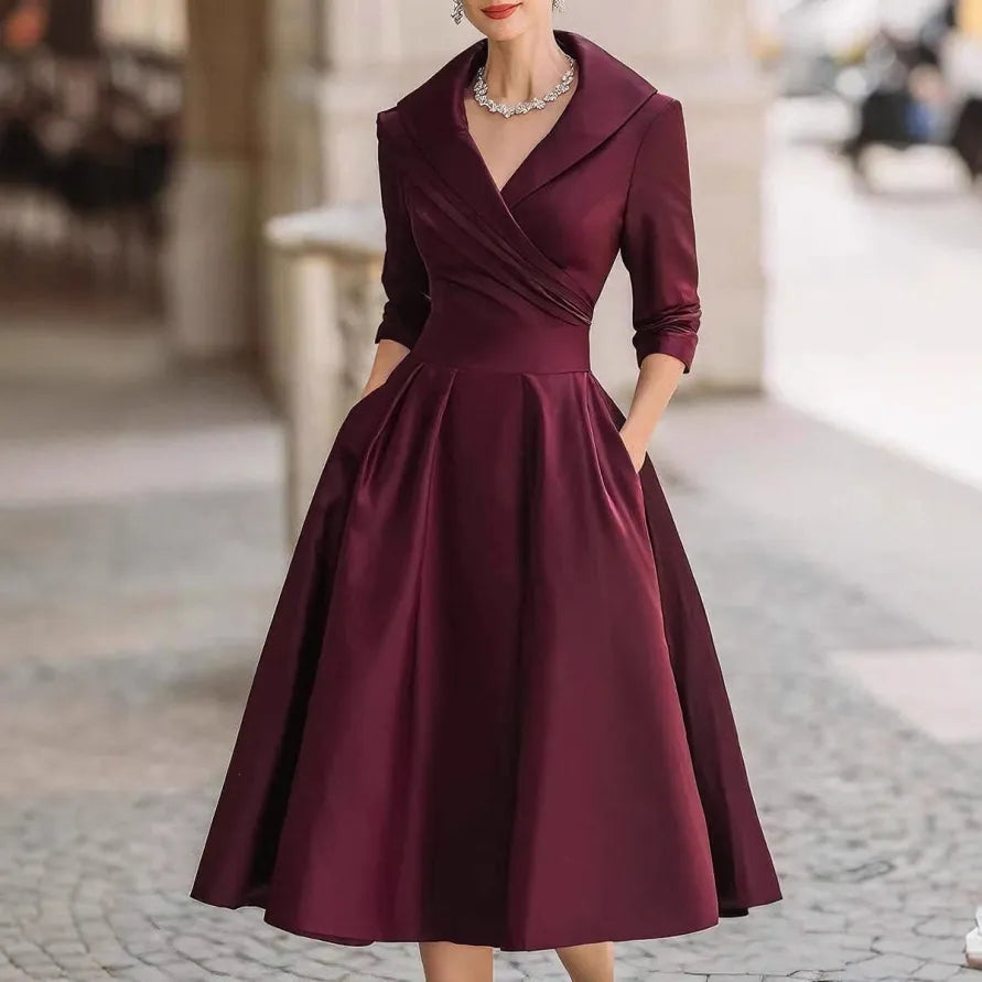 Chic women's A-line V-neck midi dress featuring three-quarter sleeves and a flattering flared skirt for various occasions.