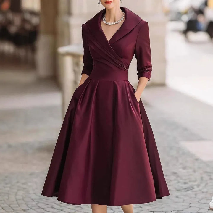 Chic women's A-line V-neck midi dress featuring three-quarter sleeves and a flattering flared skirt for various occasions.