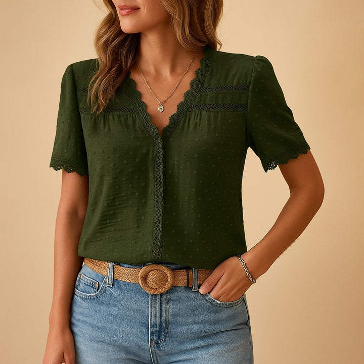 Close-up of the elegant V-neck women's top showcasing intricate lace trim and subtle Swiss dot fabric detail.