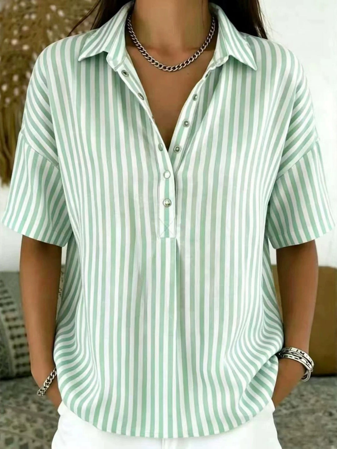Elegant women's vertical stripe half-button blouse, short sleeve, for office or casual summer fashion.