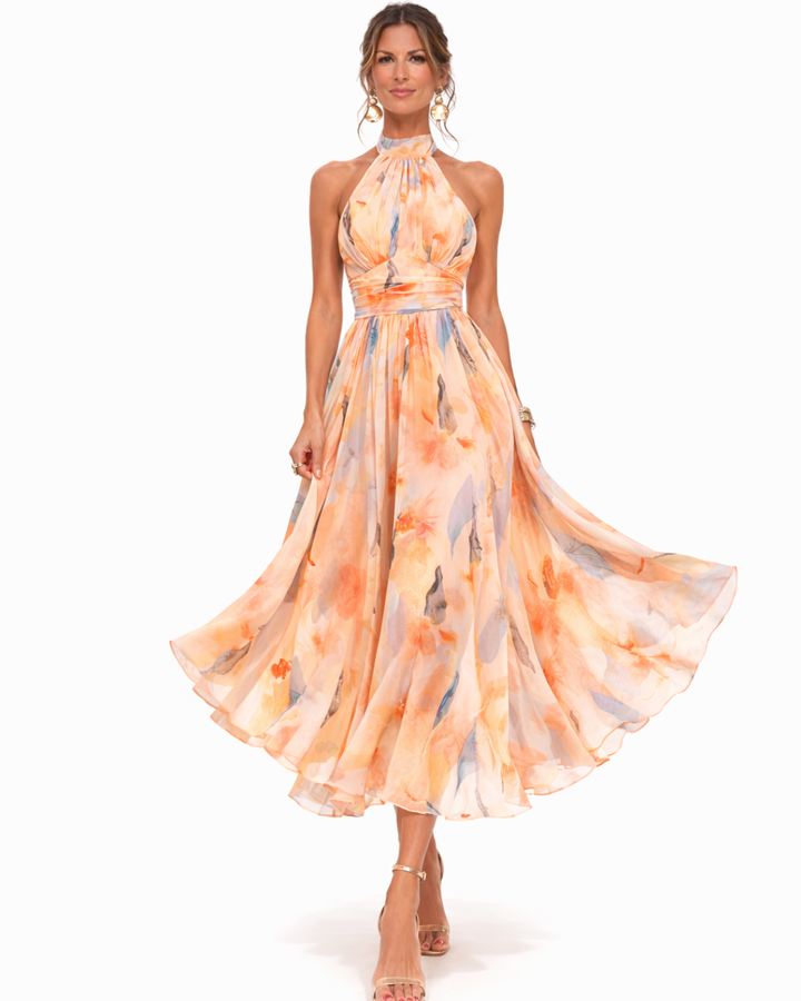 Flowing bohemian watercolor maxi dress with halter neck for elegant summer parties and casual chic events.