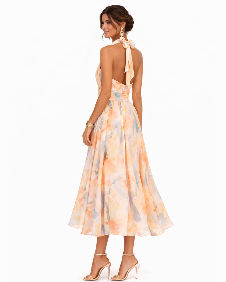 Stylish women's halter neck maxi dress featuring a beautiful watercolor print, perfect for any summer occasion.