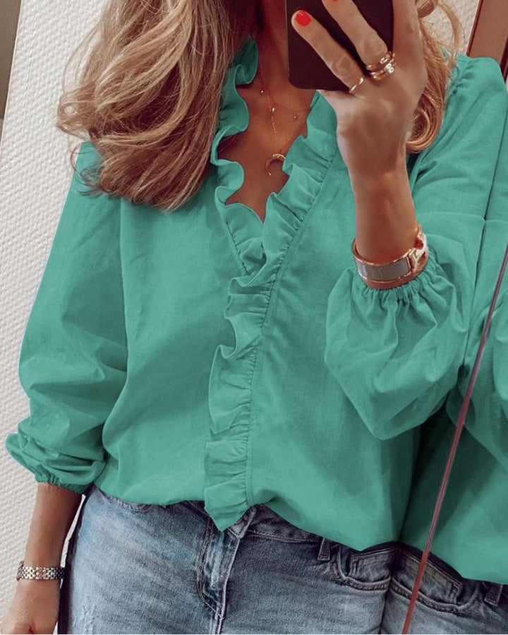 Stylish women's V-neck blouse with elegant ruffles, long sleeves, great for both casual and chic fashion looks.