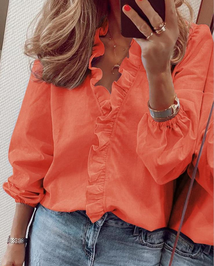 Chic women's orange ruffled V-neck blouse, long sleeve, an elegant top for versatile daily wear & fashion.