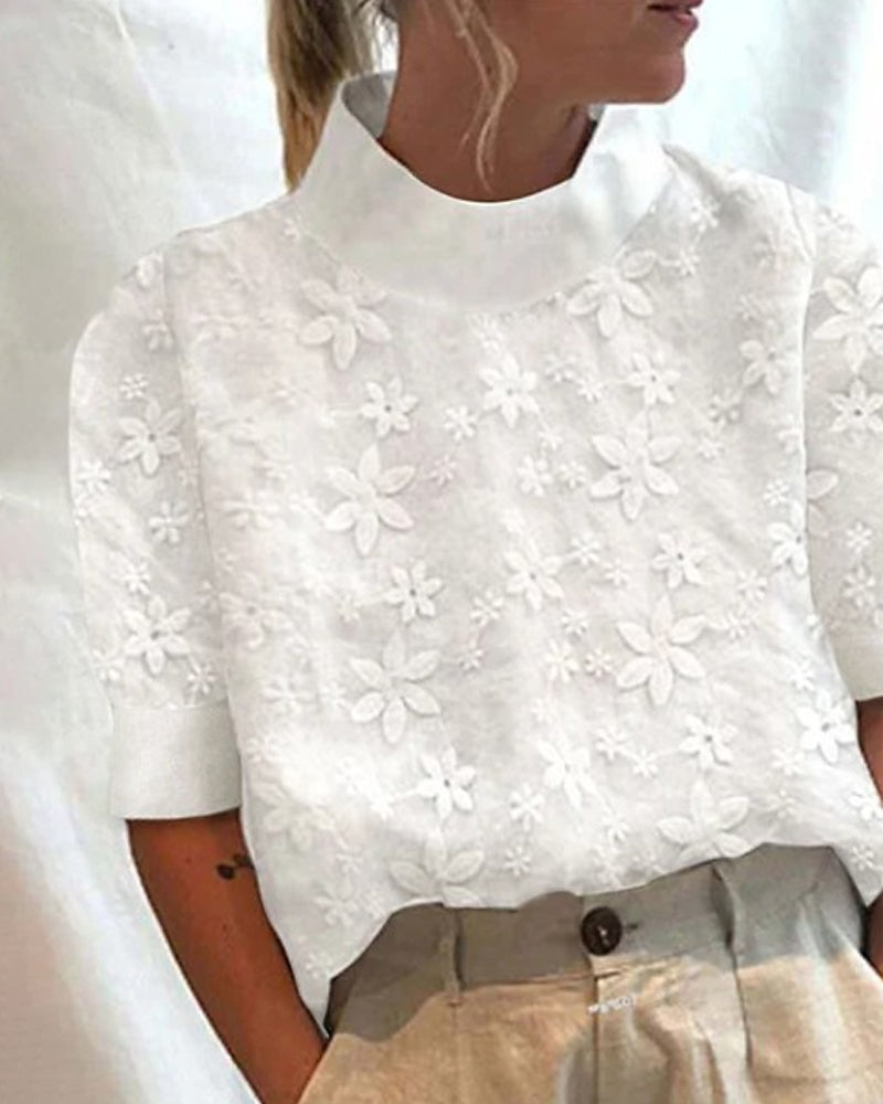 Sophisticated white women's blouse featuring a stand collar & elegant embroidery, suitable for versatile styling.