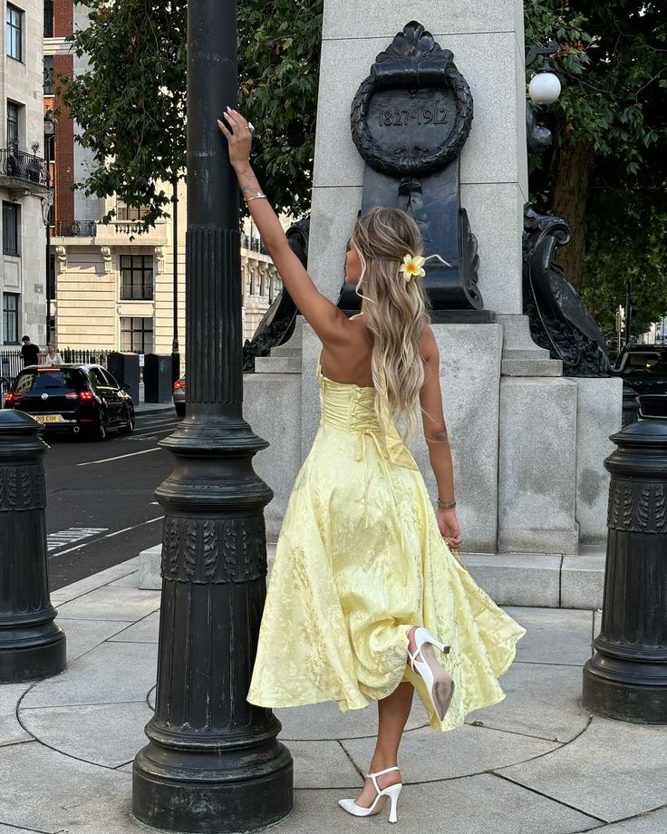 Stunning white halter midi wedding guest dress with corset details, an elegant choice for summer formal events.