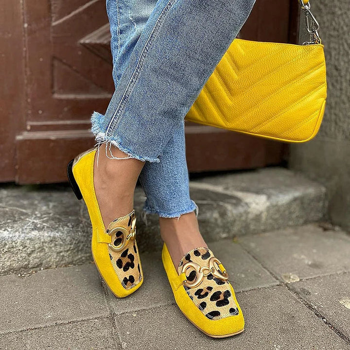 Elegant women's yellow slip-on loafers with a comfortable penny toe design, perfect for stylish office or casual wear.