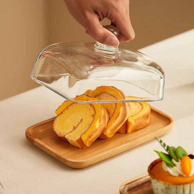 Elegant wood & glass butter dish with clear lid, perfect for serving and storing butter on your kitchen counter.