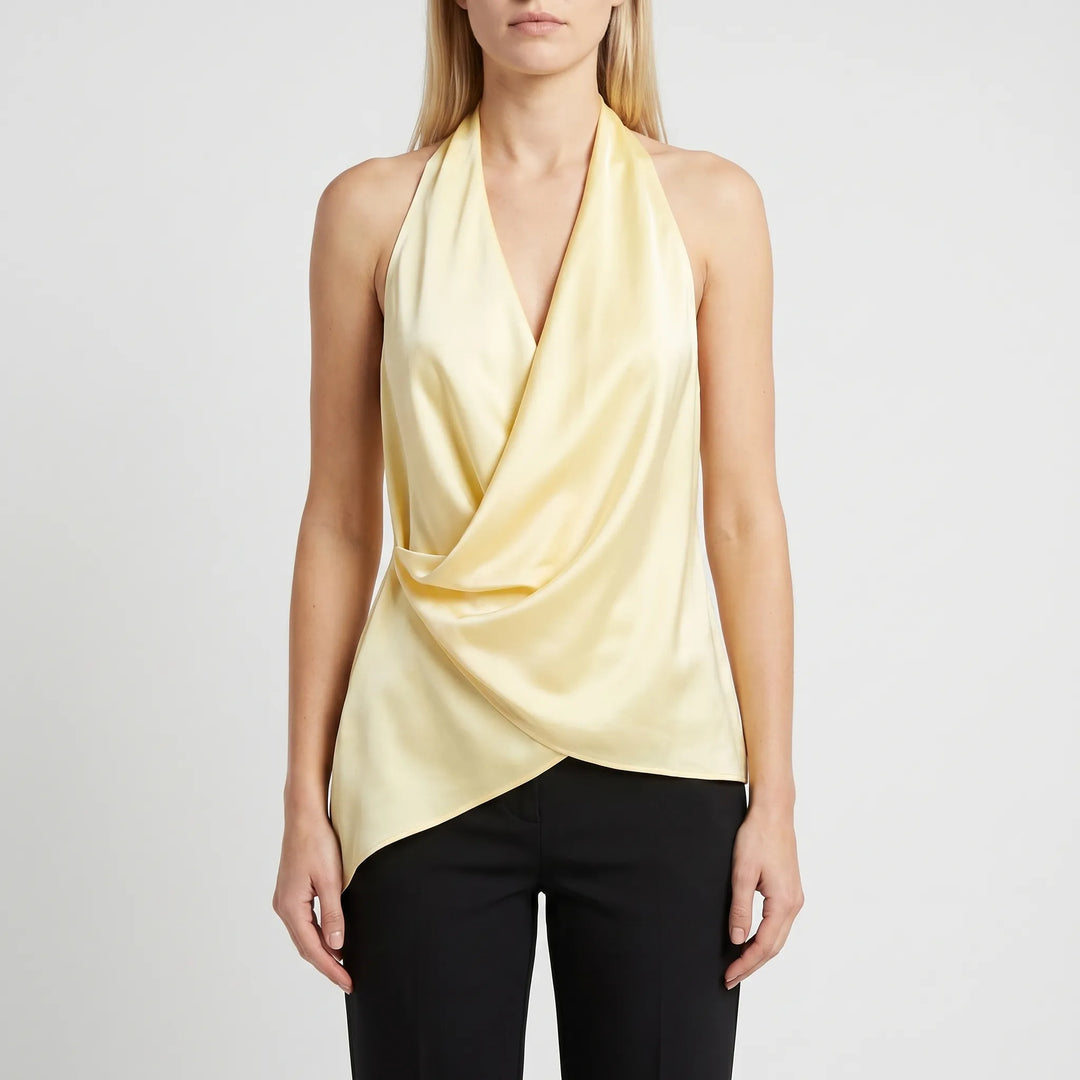 Stylish women's elegant draped halter top in yellow, sleeveless with an asymmetrical hem, perfect for summer evening wear.