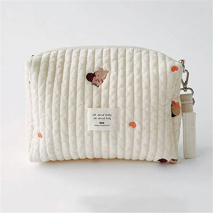 Detailed view of embroidery on a cotton stroller organizer and diaper caddy, soft baby accessory