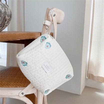 Close-up of the embroidered pattern on a cotton diaper caddy baby stroller organizer
