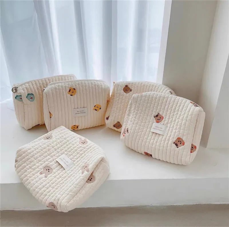 Close-up of embroidered diaper caddy bag attached to a baby stroller, newborn travel accessory