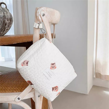 Baby stroller organizer in cotton, neatly holding baby bottles and diapers, mom essentials