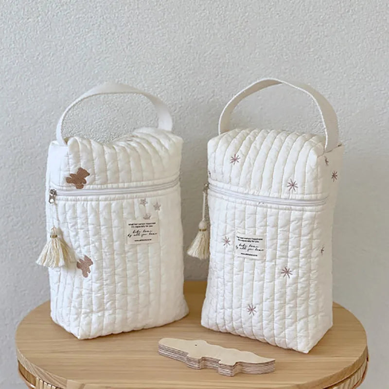 Close-up of embroidered animal on fabric diaper wet bag, perfect for stroller or travel.