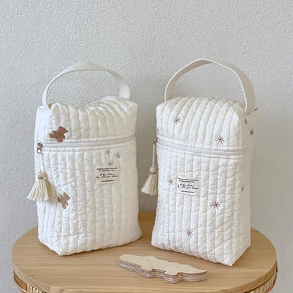 Close-up of embroidered animal on fabric diaper wet bag, perfect for stroller or travel.